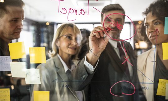 people planning on a glass wall