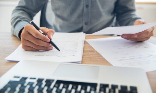 Businessman checking documents at table